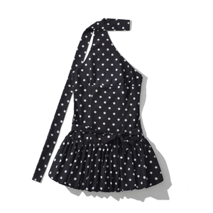 Detailed view of black polka dot halter neck mini dress with waist bow and layered ruffles