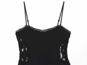 Close-up of black camisole featuring delicate floral lace inserts and adjustable straps