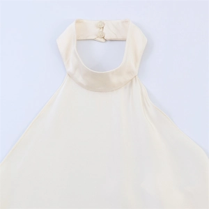 Detail view of the ivory halter neck top featuring high collar and back button closure