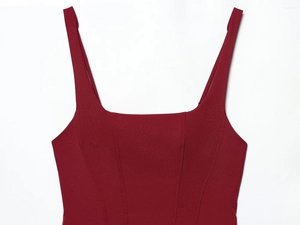 Detail of burgundy sleeveless dress featuring square neckline and vertical seam stitching