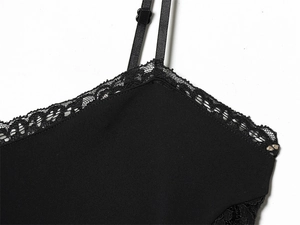 Detail of black lace trim and adjustable spaghetti strap on women's stylish mini dress