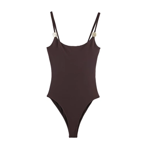 Detail of dark brown swimsuit with elegant golden shell hardware on the straps