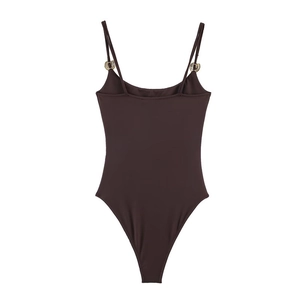 Close-up of brown bodysuit with crystal horseshoe buckle on thin shoulder straps