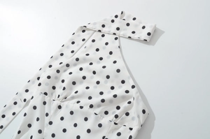 Detail of polka dot halter top neckline with elegant pleated crossover design