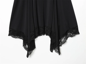 Detail of handkerchief hem with delicate black lace trim on a minimalist dress
