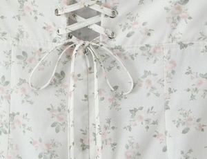 Detailed view of floral dress with lace-up corset back and invisible zipper closure