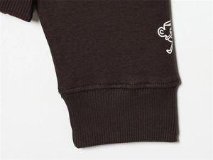 Detail of ribbed cuffs on dark brown long-sleeved dress with white mascot print