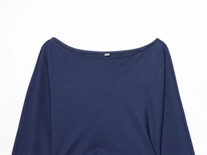 Detailed close-up of navy blue boat neck dress with soft knit texture and size S tag