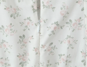 Close-up of the invisible zipper and pink rose floral print on the slim fit summer dress