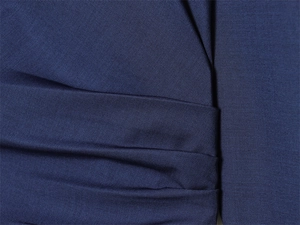 Macro shot of dark blue twill fabric texture with elegant pleat design detail