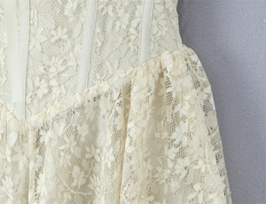Detail of floral lace corset dress featuring bustier structure and elegant draping fabric