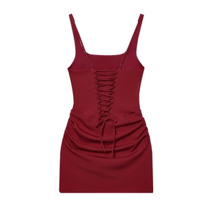 Detail view of the back of a wine red bodycon dress with adjustable lace-up straps