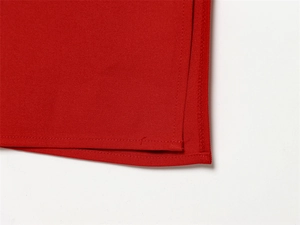 Detailed close-up showing the precise double-stitched hem on red twill fabric dress
