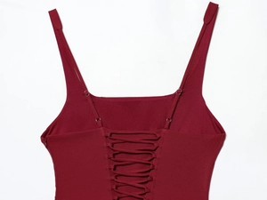 Detailed view of dark red mini dress featuring criss-cross lace-up back and thin straps