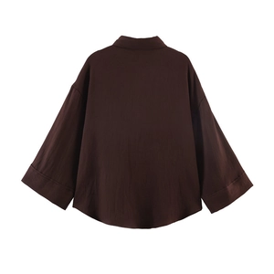 Rear view of a loose-fitting dark brown oversized shirt with wide drop shoulder sleeves