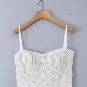 Floral print camisole top with lace trim and pink bows on a white base color