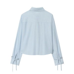 Back view of light blue striped cropped poplin shirt with bow details on cuffs