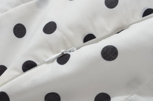 Detail of the high-quality invisible zipper on a white black polka dot halter dress