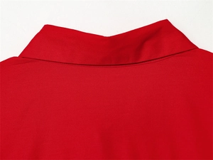 Detailed close-up of vibrant red poplin shirt collar with precise stitching and fabric texture