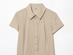 Detail of khaki short sleeve shirt dress with lapel collar and metal snap buttons