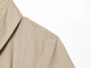 Detailed view of khaki woven shirt dress shoulder seams and epaulet stitching details
