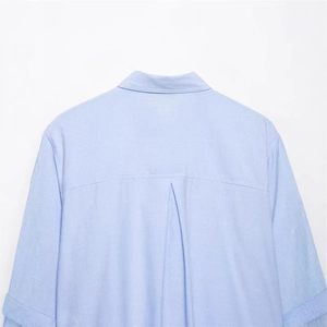 Back view of a light blue striped long-sleeved shirt with classic collar and pleat detail