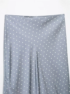 Close-up of blue-grey satin fabric with white polka dot pattern for women's skirt
