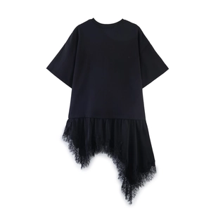 Detailed view of asymmetric lace patchwork hem on a black short sleeve t-shirt top