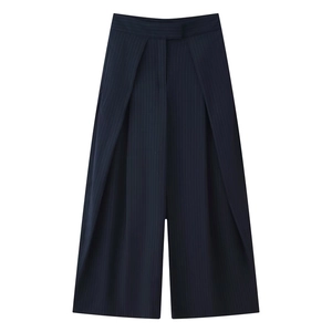 Detail of high-waist wide-leg pants with pinstripe pattern and overlapping pleat design
