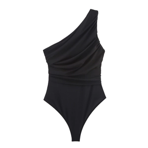 Detail of black one-shoulder bodysuit featuring asymmetric pleats and elastic fabric