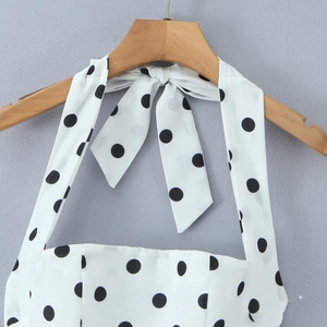Polka dot halter neck mini dress with back bow tie detail on a white sleeveless summer dress