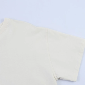 Close-up of cream crew neck T-shirt with premium knit fabric and neat double-needle stitching