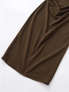 Detail view of dark brown knitted fabric showing fine plain weave texture and soft drape