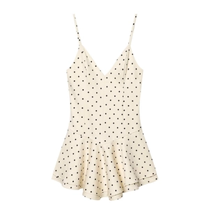 Detailed view of polka dot mini dress with spaghetti straps and layered ruffle hem