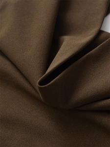 Detailed macro view of dark brown high-quality woven fabric with subtle grain texture