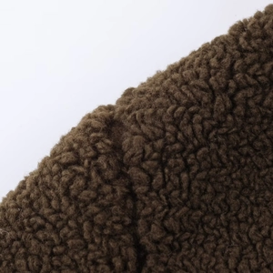 Close-up of the brown sherpa fleece fabric showing detailed winter coat texture