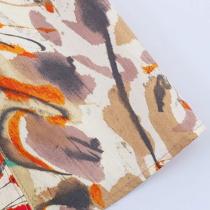Detailed macro view of abstract artistic floral print on high-quality fabric dress