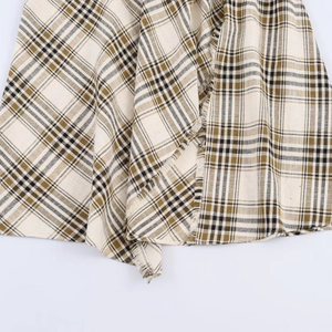 Asymmetric plaid skirt in beige and olive green with vintage frayed edges and casual style