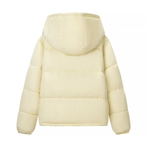 Detail view of the horizontal quilting and hooded design on a pale yellow winter jacket
