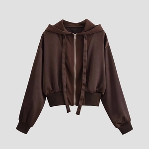 Detail of a dark brown cropped zip-up hoodie featuring wide ribbed cuffs and hem