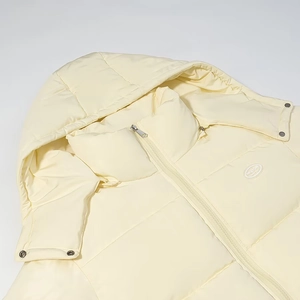 Detail of winter hooded puffer jacket with high collar and metal snap buttons