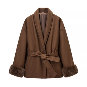 Détail d'un manteau en laine marron avec poignets en fausse fourrure et ceinture à la taille