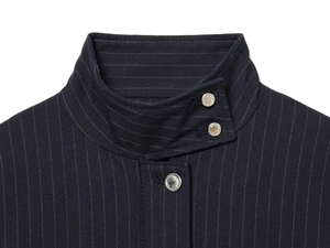Detailed view of navy blue pinstripe jacket collar with engraved silver metal buttons