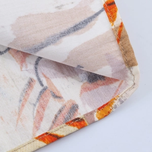 Close-up of vintage floral print fabric showing neat stitching and fine material texture