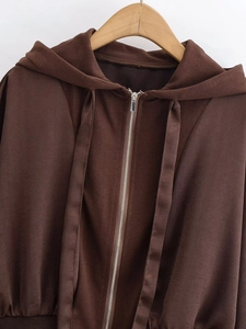 Close-up of dark brown hooded sweatshirt showing metal zipper and soft fleece texture