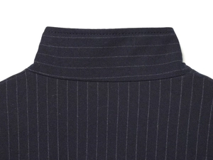 Detail of pinstripe bomber jacket collar showing premium stitching and texture