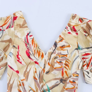 Close-up of retro floral dress featuring a deep V-neck and invisible zipper detail