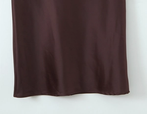 Close-up of chocolate brown satin dress hem with fine stitching and silky luster finish