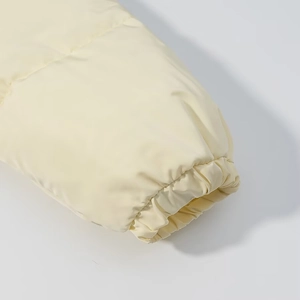Detail shot of beige winter jacket elastic cuffs with windproof stitching and matte fabric