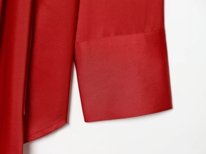 Detailed close-up of the red satin shirt cuffs showing precise stitching and fabric texture